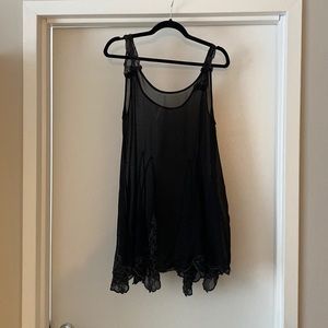 Free People black slip dress with beaded bottom and sleeves.